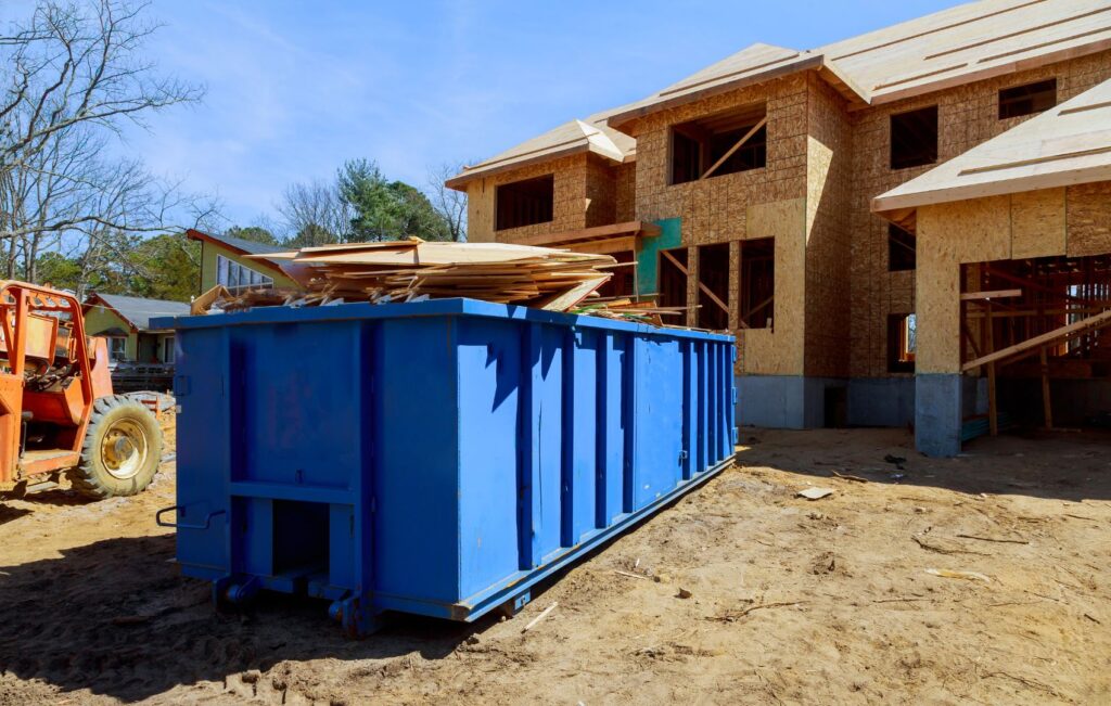 Dumpster filled with house construction supplies